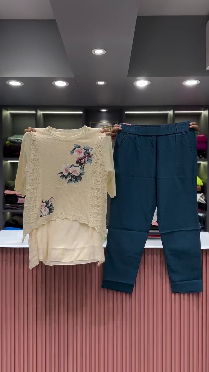 Black Open-Knit Top with Floral Appliqués and Gray Pants - Image 6