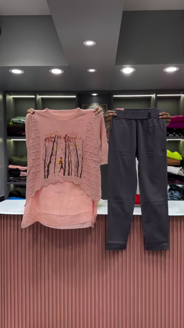 Black Open-Knit Top with Floral Appliqués and Gray Pants - Image 4