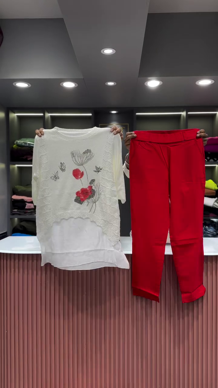 Black Open-Knit Top with Floral Appliqués and Gray Pants - Image 3