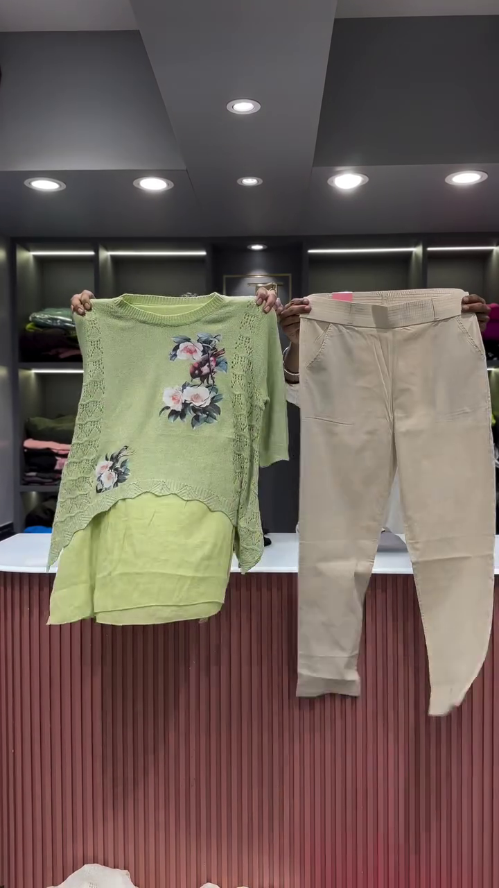 Black Open-Knit Top with Floral Appliqués and Gray Pants - Image 2