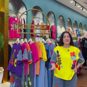 Multicolor Printed Ethnicwear Rack Display – Bold Floral & Abstract Garments in Boutique Interior with Teal-Gold Accents