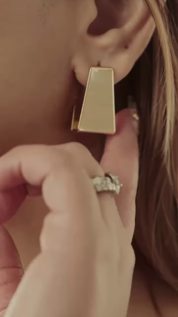 Close-Up of Stylish Gold-Toned Earrings: Teardrop, Stud, and Mesh Hoop - Image 4