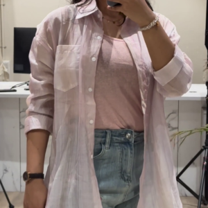 Casual Layered Outfit: Pink Button-Down Shirt, Tank Top, and Denim Shorts