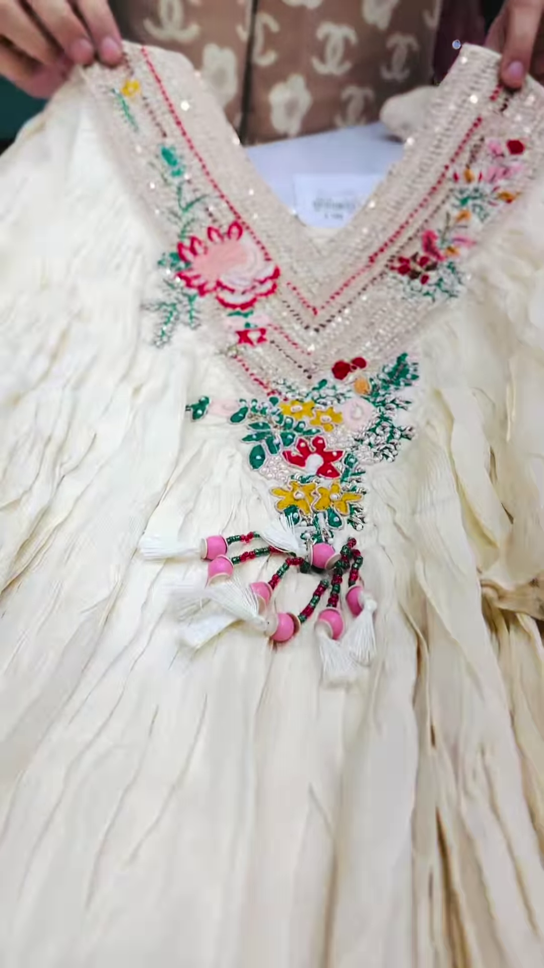 Close-Up of Ivory Crinkle-Fabric Tunic with Vibrant Floral Embroidery - Image 2