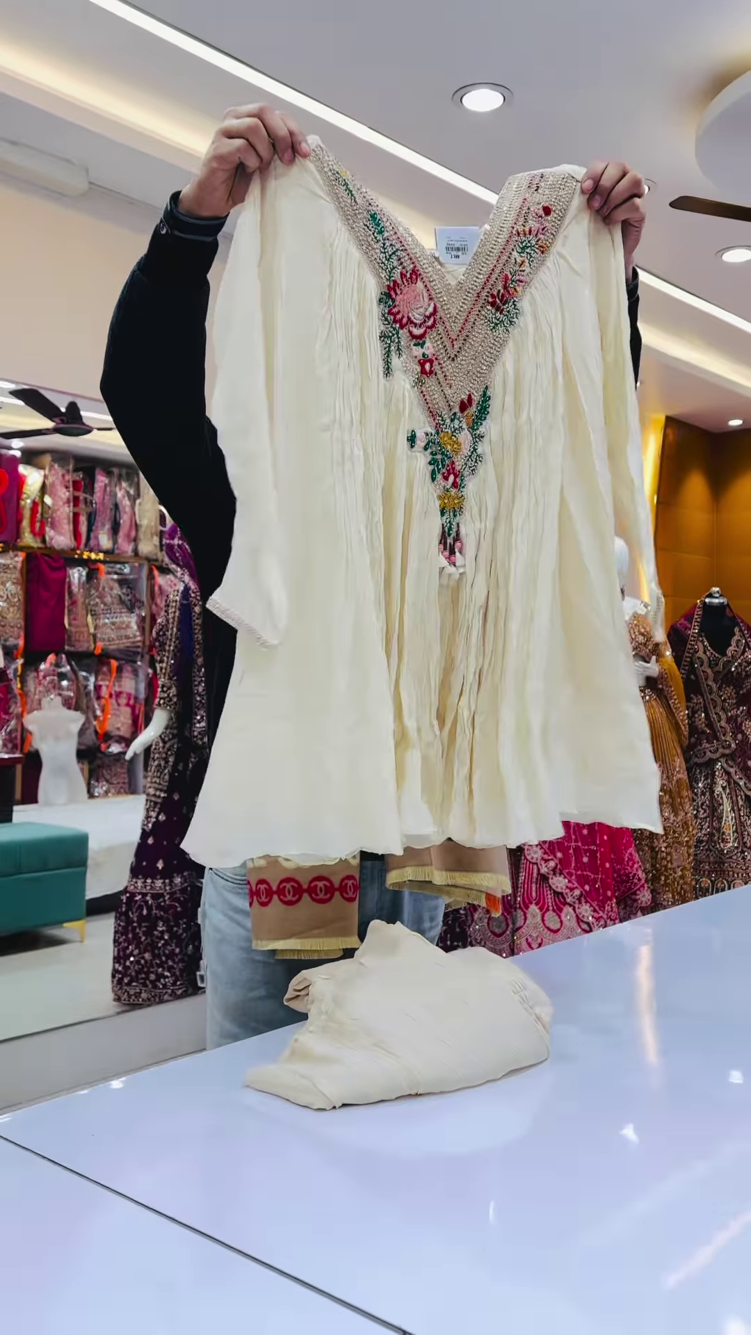 Close-Up of Ivory Crinkle-Fabric Tunic with Vibrant Floral Embroidery